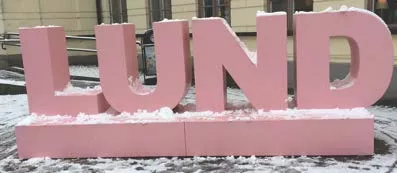 Lund in pink letters outside central station in the winter