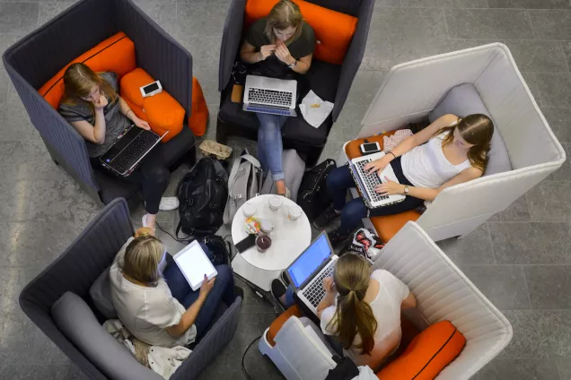 A group of studens in armchairs pictured from above